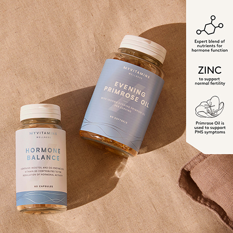 Two Myvitamins supplement bottles, one labeled Hormone Balance and the other Evening Primrose Oil, sit on a textured brown surface next to a white information panel with text reading Myvitamins Wellness Hormone Balance contains Inositol and Co-Enzyme Q10. Vitamin B6 contributes to the regulation of hormonal activity 60 Capsules Myvitamins Wellness Evening Primrose Oil with 1000mg Evening Primrose Oil per serving 90 Softgels Expert blend of nutrients for hormone function ZINC to support normal fertility Primrose Oil is used to support PMS symptoms.