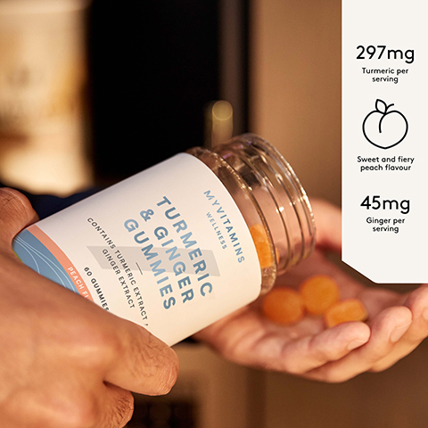 A person holds a bottle of Myvitamins Wellness Turmeric & Ginger Gummies, with several orange gummies in their cupped hand, and the visible text includes Myvitamins Wellness, Turmeric & Ginger Gummies, 60 Gummies, Peach Flavour, 297mg Turmeric per serving, Sweet and fiery peach flavour, and 45mg Ginger per serving.